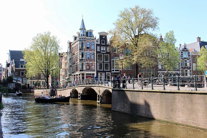 Amsterdam Canal Tour by Open Boat – 90 min Small Group Experience - The Old Church, red lights, and Amsterdam’s oldest waterways