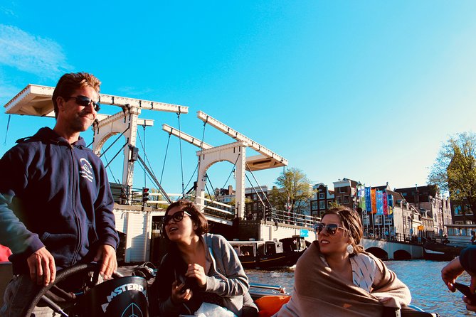 Amsterdam Canal Tour by Open Boat – 90 min Small Group Experience - Munt Tower and the southern edge of De Wallen