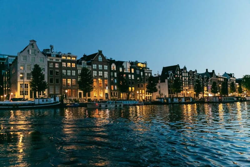 Amsterdam: Evening Cruise with Optional Wine and Snacks - Amsterdam after dark, seen from the canals