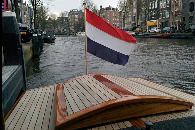 Amsterdam small-group canal cruise in 1920s saloon boat - A guide-led experience, not an audio loop