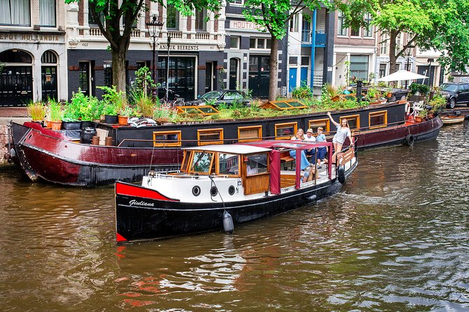 Amsterdam Small-Group Canal Cruise With Dutch Snacks and Drink - Crossing the Amstel River and Amsterdam’s famous bridge