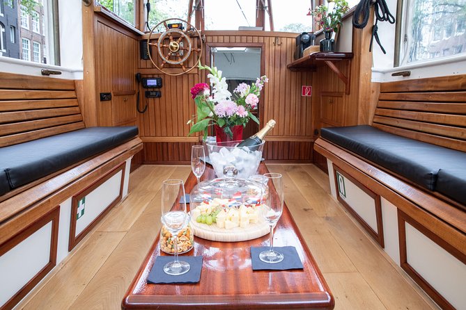 Amsterdam Small-Group Canal Cruise With Dutch Snacks and Drink - Local snacks, Dutch drinks, and the hot-food stop