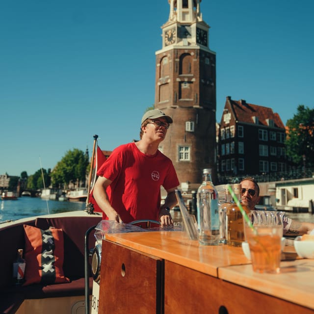 COZY AND FUN CANAL TOUR: A UNIQUE JOURNEY THROUGH AMSTERDAM - A small boat at Oudezijds Voorburgwal 226